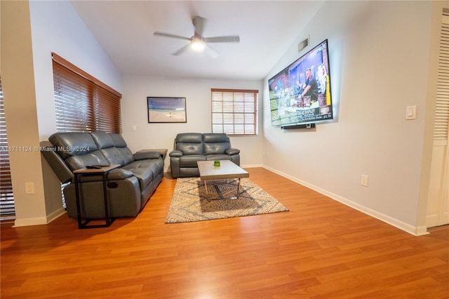 living room with light wood-type flooring, vaulted ceiling, and ceiling fan