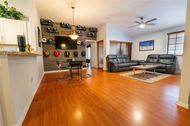 living room featuring ceiling fan, vaulted ceiling, and hardwood / wood-style flooring