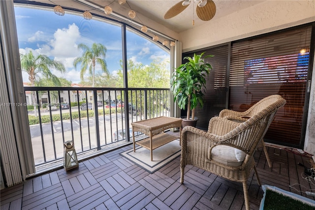 sunroom / solarium featuring ceiling fan and vaulted ceiling