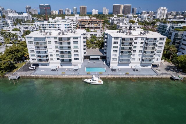 drone / aerial view featuring a water view and a view of city
