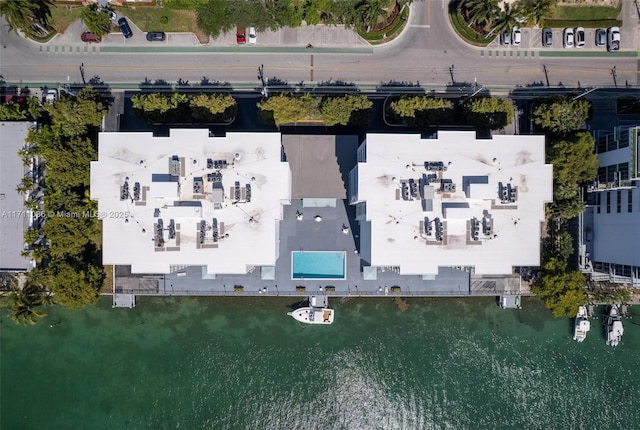 birds eye view of property with a water view