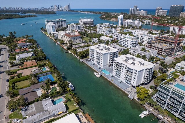 drone / aerial view featuring a city view and a water view