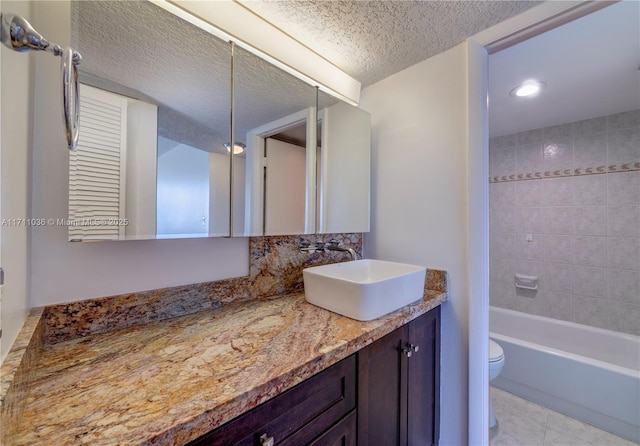 bathroom featuring tasteful backsplash, toilet, vanity, a textured ceiling, and  shower combination