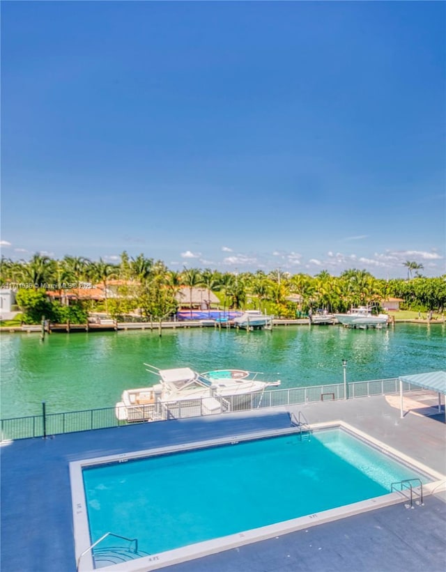 view of pool featuring a dock and a water view