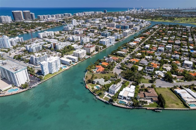 birds eye view of property featuring a city view and a water view