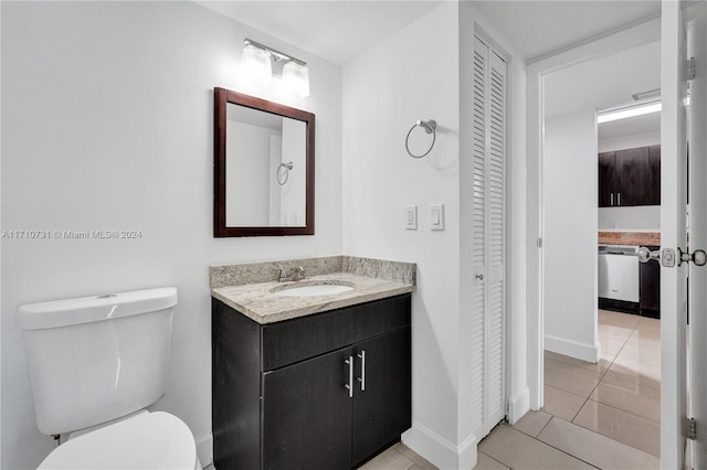 bathroom featuring tile patterned flooring, vanity, and toilet