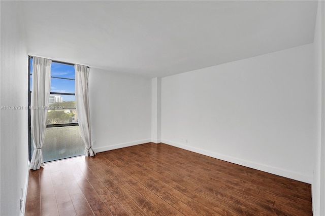 unfurnished room featuring hardwood / wood-style flooring