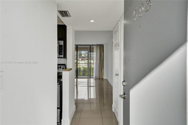 corridor featuring light tile patterned floors