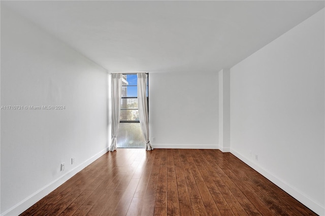 unfurnished room with dark hardwood / wood-style floors