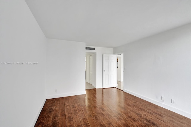 spare room featuring wood-type flooring