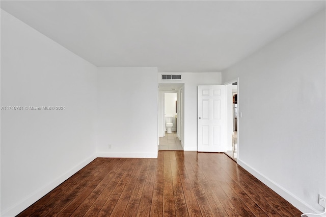 spare room with dark hardwood / wood-style floors