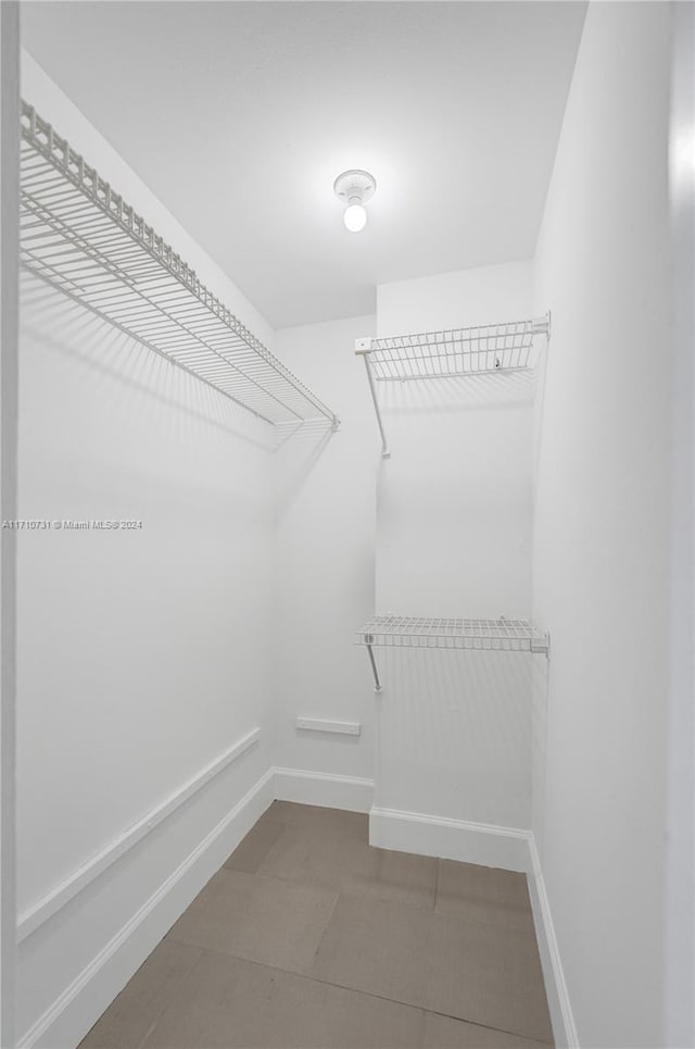 spacious closet with tile patterned floors