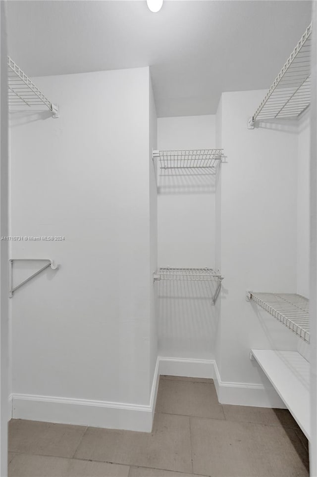 spacious closet with tile patterned floors