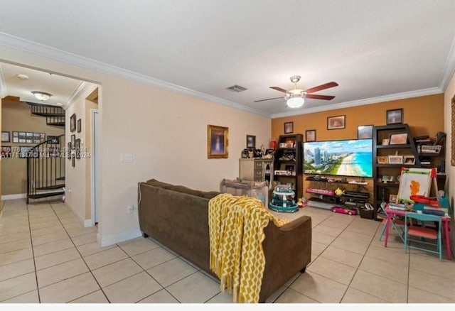 tiled living room featuring ceiling fan and crown molding