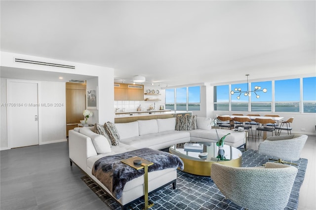 living room with a water view and a chandelier