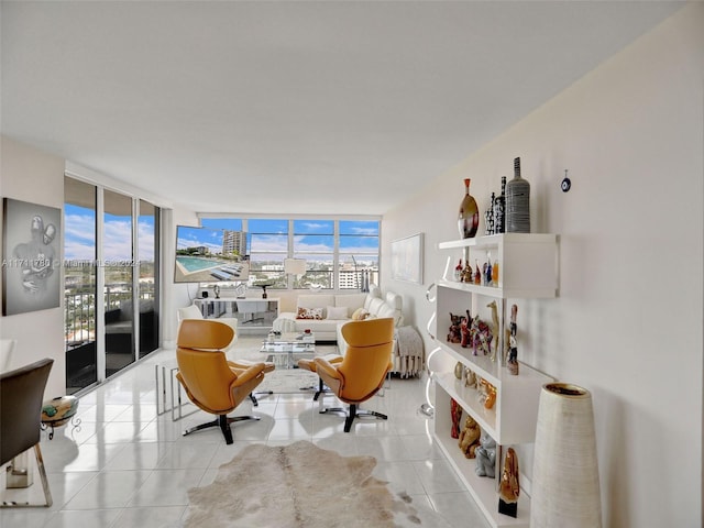 sitting room with light tile patterned floors and a wall of windows