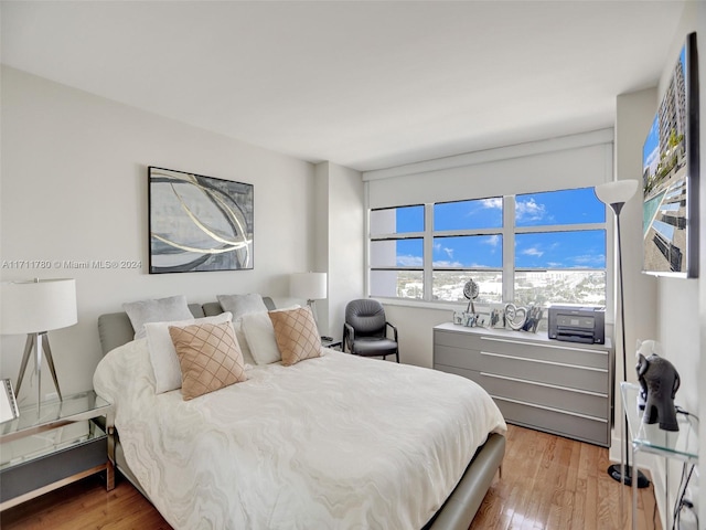 bedroom with hardwood / wood-style floors