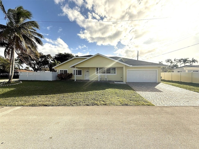 view of front of property featuring a front lawn and a garage