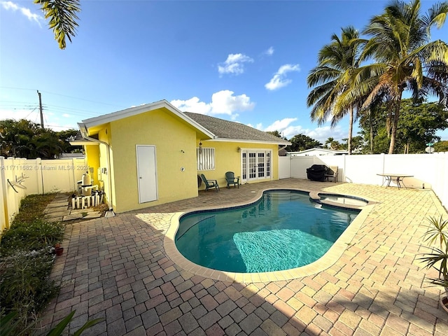 view of swimming pool with a patio area and french doors