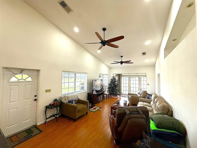 living room featuring hardwood / wood-style floors, high vaulted ceiling, plenty of natural light, and ceiling fan