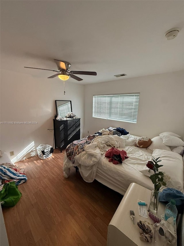 bedroom featuring ceiling fan and dark wood-type flooring