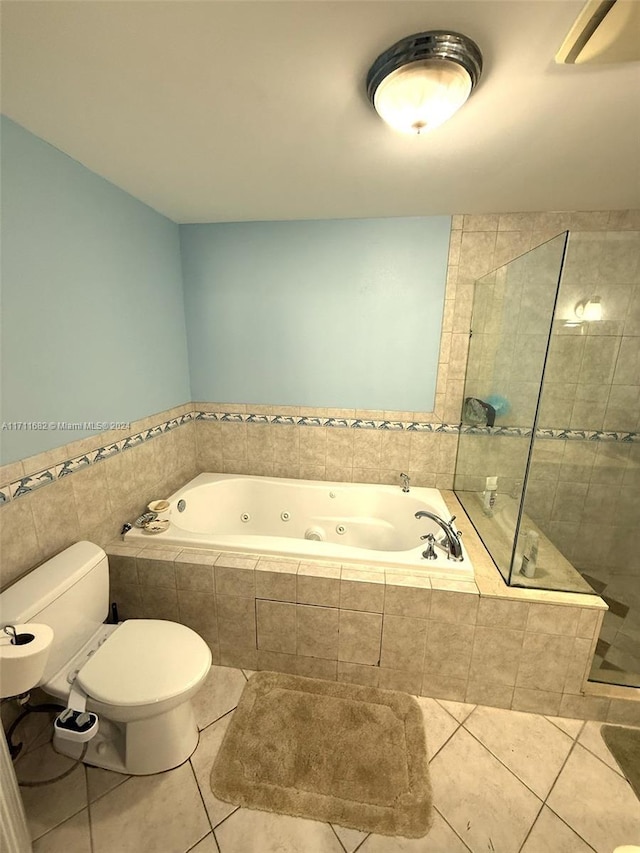 bathroom featuring tile patterned flooring, separate shower and tub, and toilet