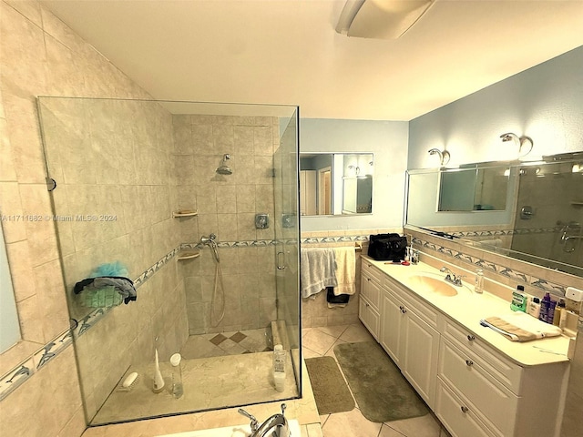 bathroom featuring tile patterned flooring, vanity, and a shower with door