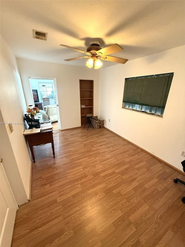 interior space with ceiling fan and wood-type flooring