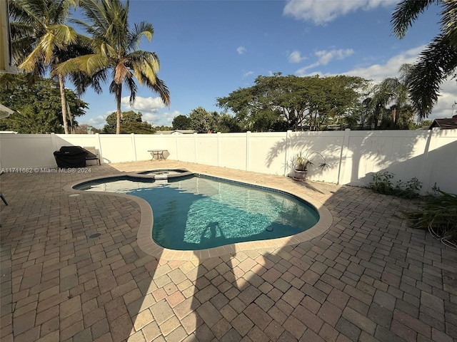 view of pool featuring an in ground hot tub and a patio