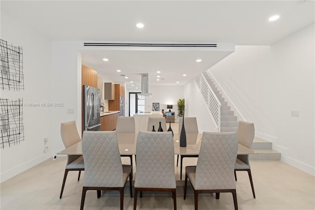 909 NE 16th Ave, Fort Lauderdale, FL 33304 - dining space featuring light colored carpet, stairs, baseboards, and recessed lighting