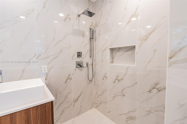 bathroom featuring vanity and tiled shower