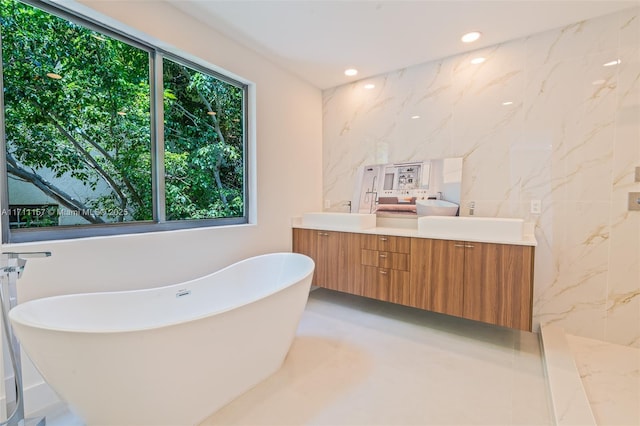 909 NE 16th Ave, Fort Lauderdale, FL 33304 - full bath with double vanity, a freestanding tub, and recessed lighting