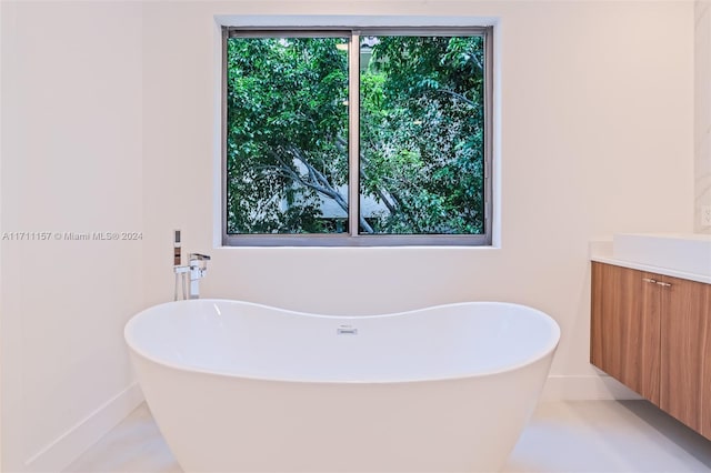 bathroom with vanity and a tub to relax in