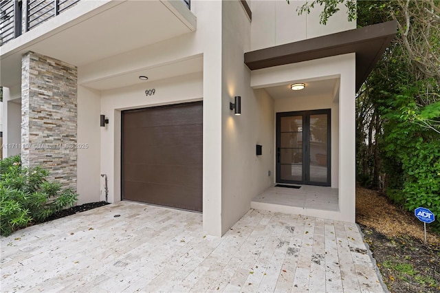 909 NE 16th Ave, Fort Lauderdale, FL 33304 - property entrance with stone siding, french doors, and stucco siding