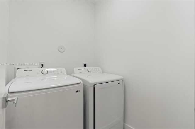 clothes washing area with separate washer and dryer