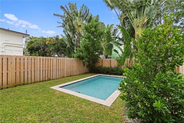 view of pool with a lawn