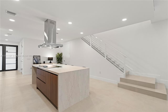 kitchen featuring island range hood, black electric stovetop, and a center island