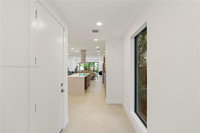 hallway featuring light tile patterned floors