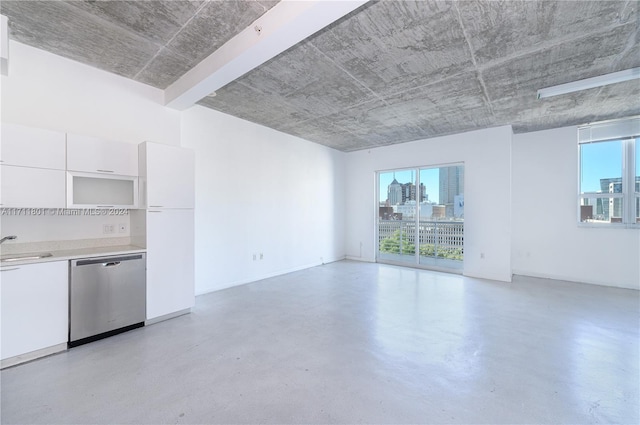 unfurnished living room with plenty of natural light and sink