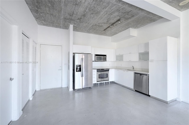 kitchen featuring white cabinets, stainless steel appliances, and sink