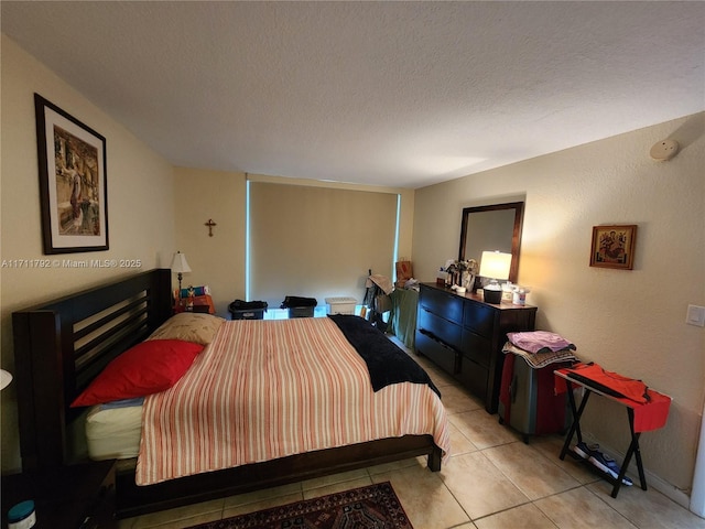 tiled bedroom with a textured ceiling