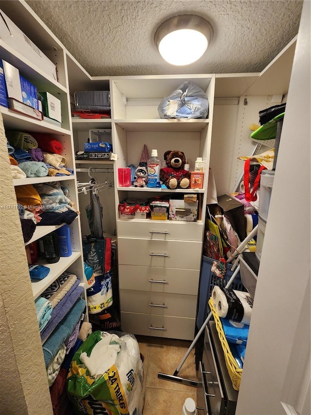 spacious closet featuring tile patterned flooring