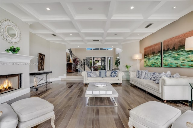 living room with beamed ceiling, wood-type flooring, and coffered ceiling