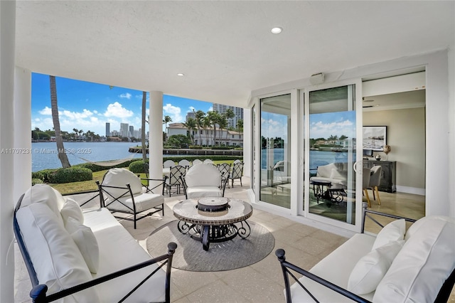 view of patio featuring a water view and outdoor lounge area