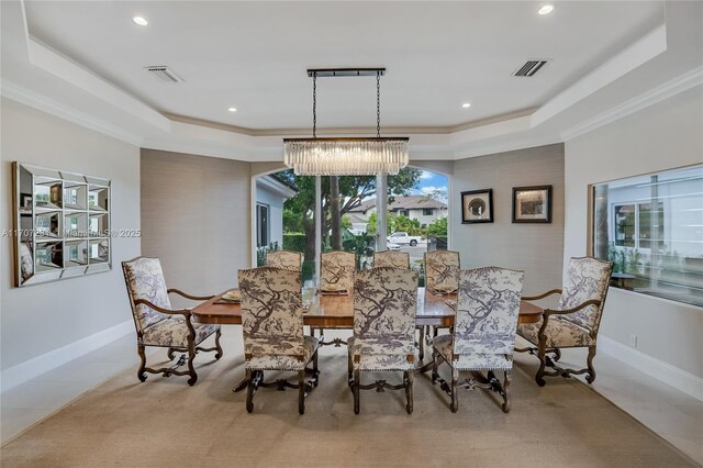 tiled dining space with a raised ceiling and an inviting chandelier