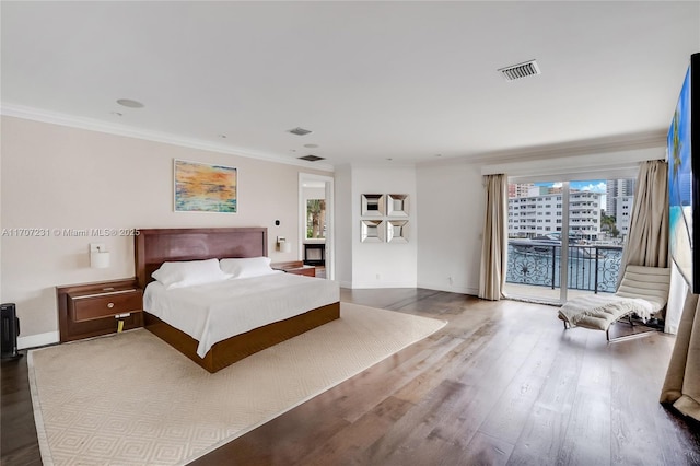 bedroom with crown molding, access to outside, and hardwood / wood-style flooring