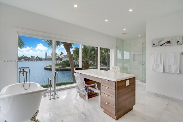 bathroom featuring a water view, vanity, and independent shower and bath