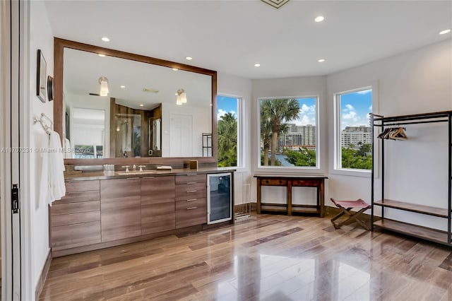 bathroom featuring wine cooler, vanity, and a shower