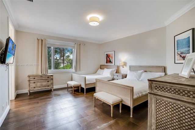 bedroom with crown molding and dark hardwood / wood-style floors