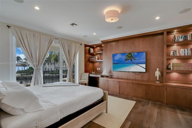 bedroom with ornamental molding and dark hardwood / wood-style flooring